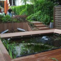 Après pièce d'eau + terrase en bois et palissade de bois